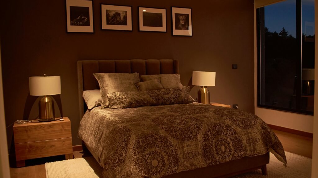 a bedroom with a large bed and a night stand