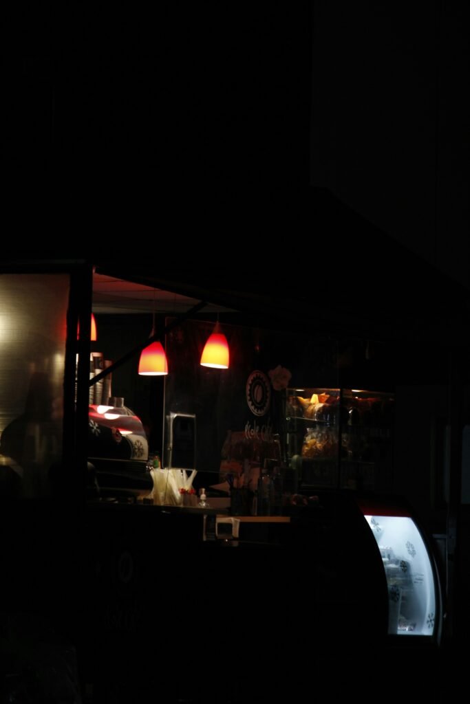 a dark room with a counter and lights